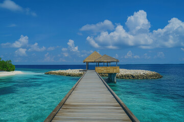 Fototapeta premium A scenic pavilion on a small island surrounded by crystal-clear blue waters and fluffy clouds, embodying the essence of tropical paradise and inviting relaxation.
