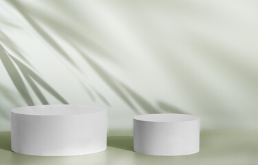 White display product pedestals against green wall with soft foliage shadows