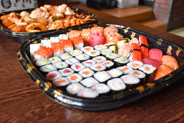 Colorful sushi set with rice. Garnish with pickled ginger and wasabi. Rolled sushi with avocado, mushrooms, tuna, salmon and sesame. With red caviar. Japanese food
