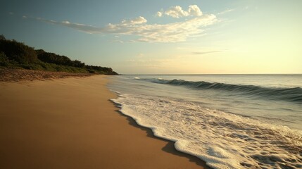 Golden hour beach view with gentle waves and a cloudy sky over the horizon