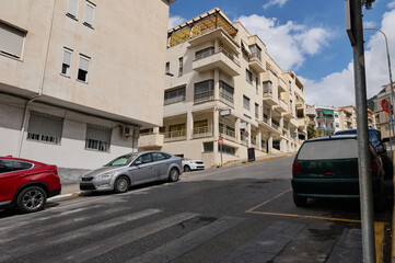 Residential street with parked cars on a sunny day