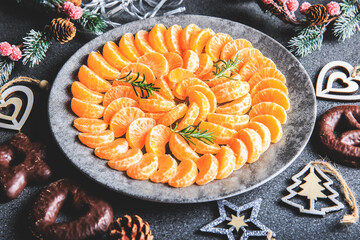 plate of clementine wedges arranged in a circle with christmas decoration