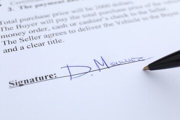 Ballpoint pen and signature on contract, closeup
