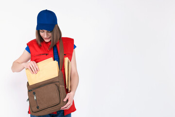 Happy postwoman with bag and envelopes on white background