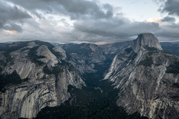 Sunset on Half Dome, as seen from Glacier Point. The tip of half dome is shrouded in cloud