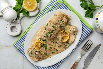 Oven baked Nile Perch Fillet, with garlic, lemon and spices. Top view.