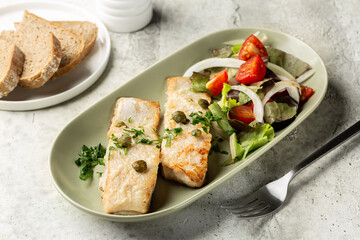 Perch fish fillet  pan fried with butter and cappers and fresh vegetables, salad.