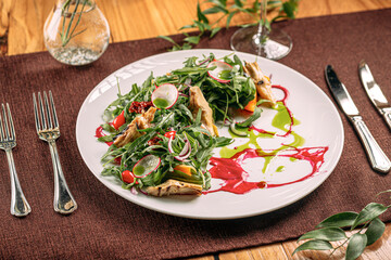 Portion of gourmet fresh salad with artichokes and sauce