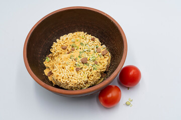 Instant pasta with herbs and spices in a bowl on a white background.