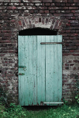 Wooden door in an old brick wall.