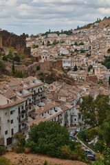 Fototapeta premium Hillside town with traditional architecture under cloudy skies