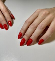 Red manicure on oval nails