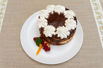 Delicious layered dessert with chocolate and cream on a white plate