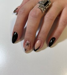 Black elegant manicure on oval nails with design