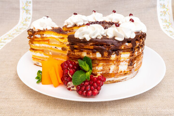 Delicious layered cake served with fresh fruit and whipped cream details