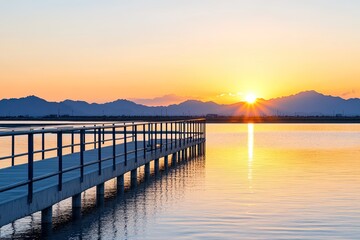 Fototapeta premium Serene sunset over a tranquil lake with a wooden pier extending into the water
