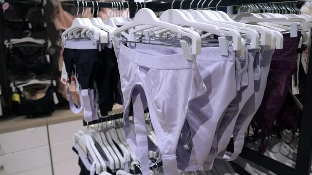 Women's bras hanging on a hanger in a clothing store. Women's underwear, women's underwear store.