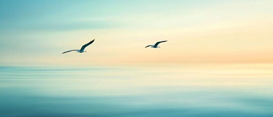 Two seagulls gracefully glide over a tranquil, pastel-colored ocean at twilight, under a serene, expansive sky.