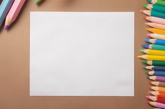 White sheet of paper lying on the table, colored pencils lying around, mockup, space for text or drawing.