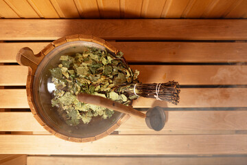 Interior of wooden sauna. Relax in hot sauna with steam. Interior of Finnish sauna classic wooden with hot steam. Wooden interior baths, wooden benches and loungers Accessories Sauna spa complex