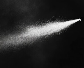 Fine spray mist from nozzle on black background.
