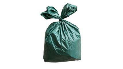 A neatly tied green garbage bag ready for disposal on a clean street during bright daylight