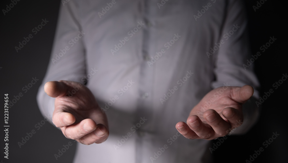 Poster man with empty hand on dark background