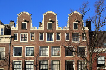 Fototapeta premium Amsterdam Keizersgracht Canal House Facades with Neck Gables and Blue Sky Close Up, Netherlands