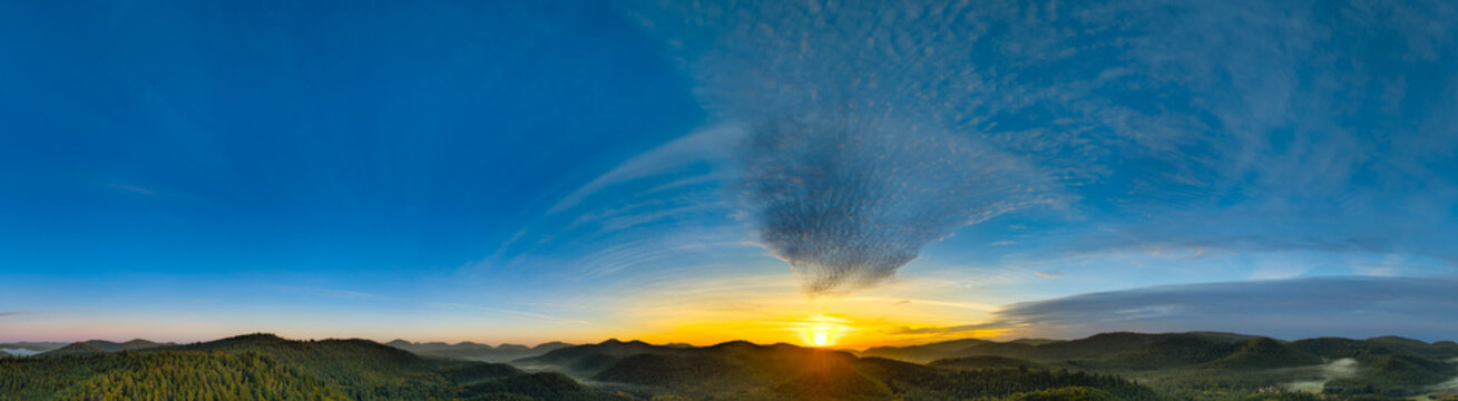 Sunrise in the Palatinate Forest with clouds moving towards the sun like a  flock of birds