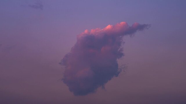 Time lapse - Beautiful single cloud at sunset in the city sky and changing shape -