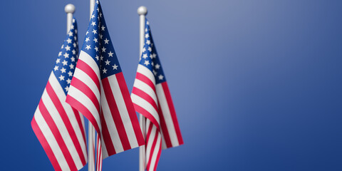 Flags of the United States of America in front of  a blue background. Selective focus on front...