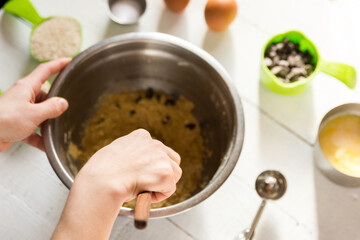 makine chocolate chip cookies, with white background