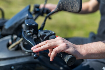 A man is riding a motorcycle with his hand on the throttle