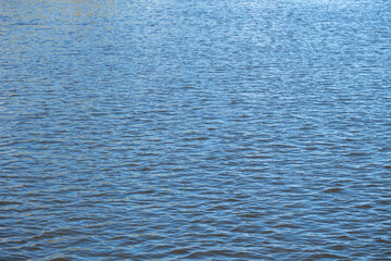 perspective view from a low point on the water surface, ripples on the lake