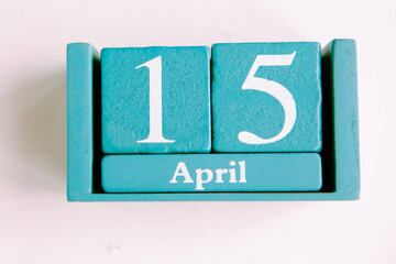 April 15. Blue cube calendar with month date isolated on white background.
