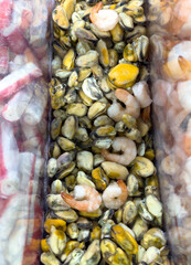 A bag of shrimp and other seafood is sitting on a table