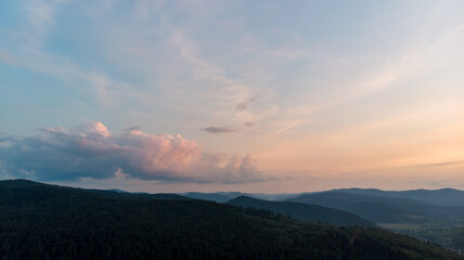Aerial View Of Majestic Mountains Shrouded In Clouds And Mist, Overlooking Expansive Agricultural Fields And A Quaint Small Town, Capturing The Serene Beauty Of The Countryside.	
