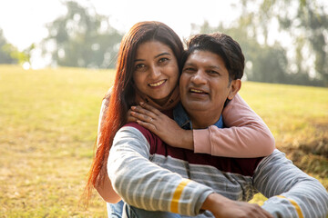 Indian young romantic couple hugging at outdoor. Lovely couple embracing each other at park