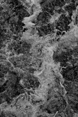 Turbulent foaming water at rapids.