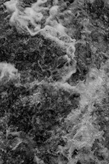 Turbulent foaming water at rapids.