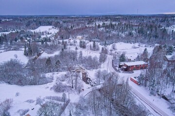 Aerial view of Kuhakoski rapids on a cold winter day with snow covered ground and tree branches, Nurmij&auml;rvi, Finland.