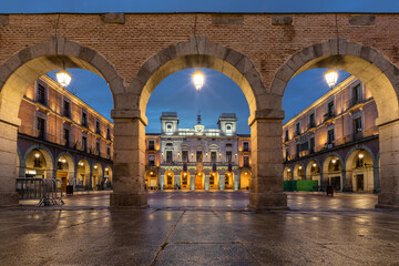 Avila, Spain. View of historic  Town Hall through the arch on Market square (Plaza Mercado Chico)