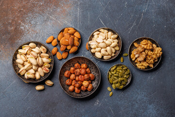 A vibrant assortment of various nuts, including almonds, walnuts, hazelnuts, cashews, and pistachios