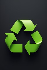 a close up of a green recycle sign on a black background