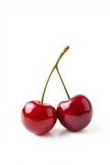 two cherries are sitting on a white surface with a white background