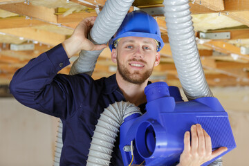 happy builder screwdriver repairing the ventilation grates