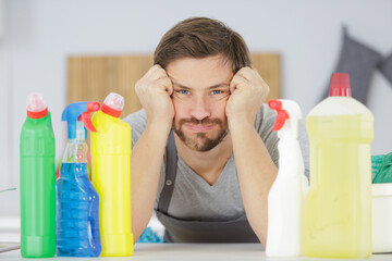 tired man next to cleaning counter in kitchen