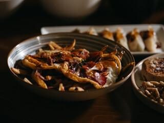Fries with ham and eggs in the table