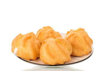Four eclairs on a ceramic saucer on a white background, close-up.