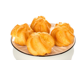 Four eclairs on a ceramic saucer on a white background, close-up.